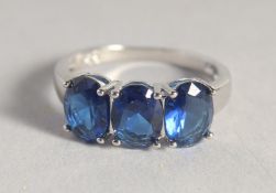 A SILVER THREE STONE SAPPHIRE RING.
