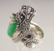 A SILVER AND JADE DRAGON RING.