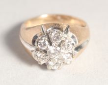 A GENTLEMAN'S 18CT GOLD SEVEN STONE CIRCULAR DIAMOND RING.