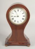 AN EDWARDIAN MAHOGANY BALLOON SHAPED CLOCK on four bun feet. 9ins high.
