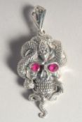A SILVER SKULL AND SNAKE PENDANT.