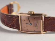 A GENTLEMAN'S 14CT GOLD BULOVA WRISTWATCH with leather strap. No. 6984824.