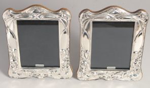 A PAIR OF SILVER ART NOUVEAU DESIGN PHOTOGRAPH FRAMES. 7.5ins x 6ins.