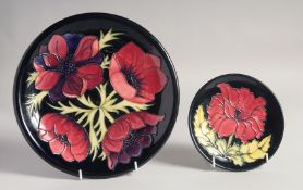 MOORCROFT ANEMONE DESIGN CIRCULAR PLATE on a black ground. Dated, '94. and a small dish by Sarah