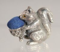 A SILVER SQUIRREL PIN CUSHION.