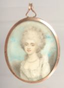 AN 18TH CENTURY OVAL PORTRAIT MINIATURE OF A LADY with blue enamel back. 2.25ins x 2.25ins.