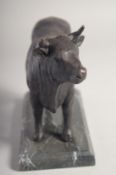 A BRONZE STANDING BULL on a marble base. 9ins long.