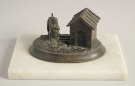 A BRONZED OVAL INKSTAND with a dog, on a marble base. 6.5ins.