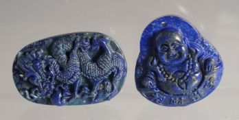 TWO CHINESE CARVED LAPIS PENDANTS.