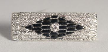 A GOOD ART DECO PLATINUM DIAMOND AND BLACK ENAMEL BROOCH. 1.5ins long.