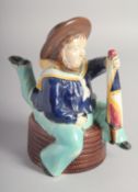 A MINTON MAJOLICA ISLE OF MAN THREE LEGGED SAILOR TEA POT AND COVER with brown hat and fashioning