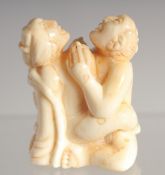 A CARVED BONE EROTIC NETSUKE. 1.5ins long.