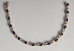 A 9CT GOLD SAPPHIRE AND DIAMOND LINE BRACELET.