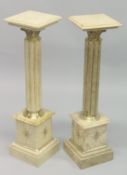 A PAIR OF BEIGE MARBLE AND ORMOLU COLUMNS. 3ft 3ins high.