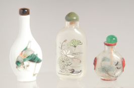 THREE CHINESE SNUFF BOTTLES on porcelain painted with a locust. Two glass, inside painted.