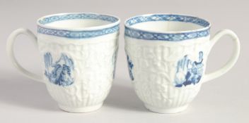 TWO LIVERPOOL CRISPLY MOULDED COFFEE CUPS with blue moulded panels painted with landscapes in blue.