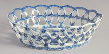 A RARE BOW OVAL BASKET painted in blue with a Chinoiserie landscaped surrounded by flowers.