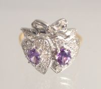 A SILVER GOLD PLATED AMETHYST DOUBLE SWEETHEART RING.