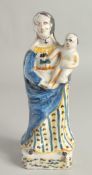 AN 18TH CENTURY FAIENCE POTTERY FIGURE, Madonna and child. 12ins high.