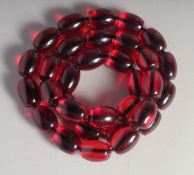 A STRING OF AMBER BEADS.