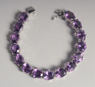 A SILVER AMETHYST LINE BRACELET.