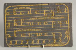 A WOODEN WRITING TEMPLATE. 6ins x 9.5in.