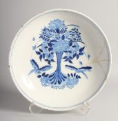 AN 18TH CENTURY DELFT BLUE AND WHITE CIRCULAR CHARGER decorated with flowers. 14ins diameter (AF)