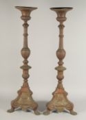A PAIR OF ITALIAN BRONZE CANDLESTICKS. 34ins high.