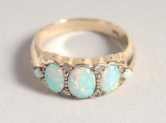 A 9CT GOLD OPAL AND DIAMOND RING
