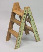A PAIR OF NOVELTY PINE CHAMPAGNE STEPS. 34ins high.