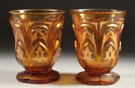 A PAIR OF AMBER TINTED BEYKOS BEAKERS. 4.75ins.