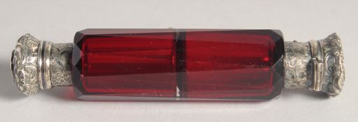 A DOUBLE ENDED SILVER TOP GLASS TAPERING SCENT BOTTLE. 5ins long.