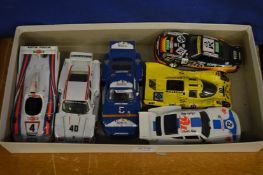Six model Porsche racing cars.
