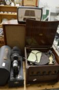 An old radiogram with a pair of speakers, bakelite radio and an old projector.