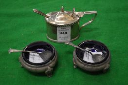 A silver oval shaped mustard pot liner and spoon together with of silver table salts with spoons.