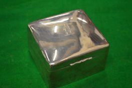 A silver cigarette box with engraved armorial.