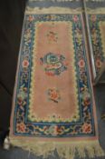A Chinese rug 140cm x 70cm.