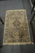 A small beige ground Persian style rug 125cm x 80cm.