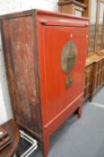 An old Chinese red lacquer two door marriage cabinet.