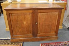 A Victorian mahogany two door collectors cabinet, the panel doors opening to reveal an arrangement
