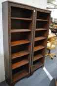 An unusual pair of oak standing tapering bookcases with carved decoration.