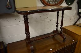 A Victorian walnut stretcher table.
