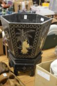 A Chinese lacquer jardiniere on stand.