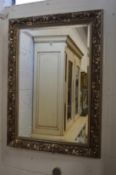 A large decorative framed mirror.