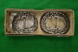 A pair of decorative buckles.