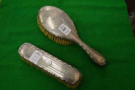 Two silver backed dressing table brushes.