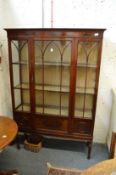 A mahogany standing display cabinet.