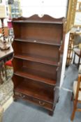 A waterfall style mahogany bookcase.