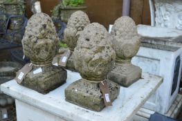 A set of four composite garden pineapple shaped finials.