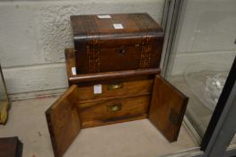 A sewing box and a walnut table top cabinet.